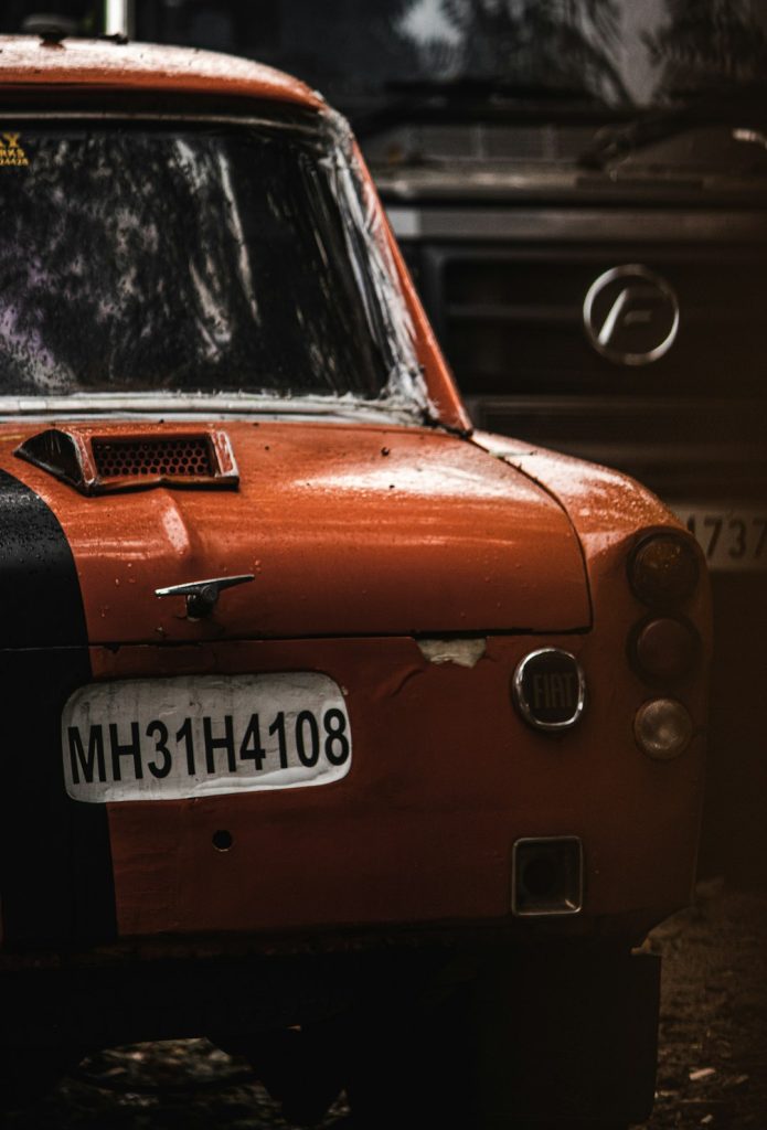 an-orange-car-with-a-black-stripe-on-it-qstgve1qng8